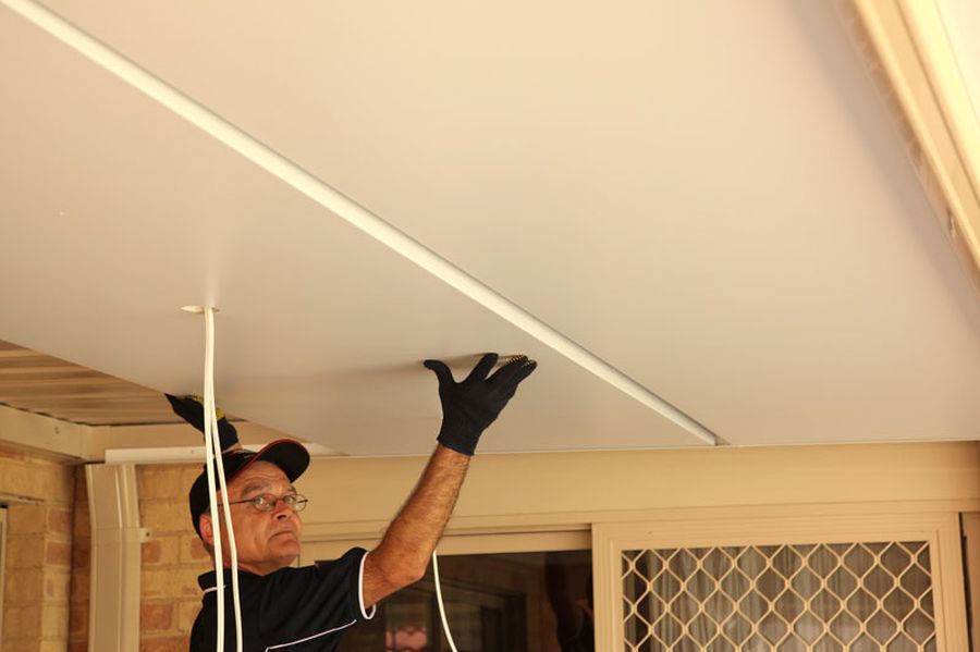 A man insulating patio roof with a Ceilink panel